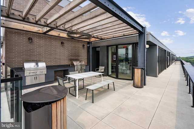 view of patio with a pergola, exterior kitchen, and grilling area