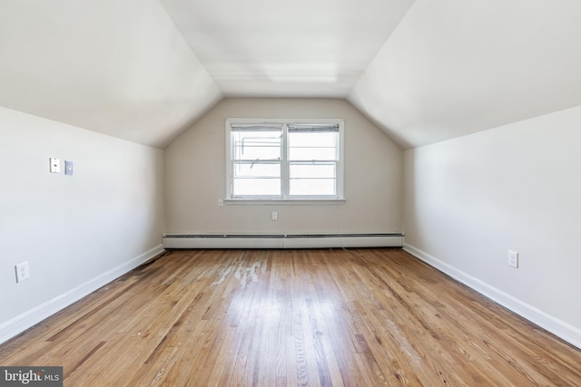 bonus room featuring lofted ceiling, light hardwood / wood-style flooring, and baseboard heating