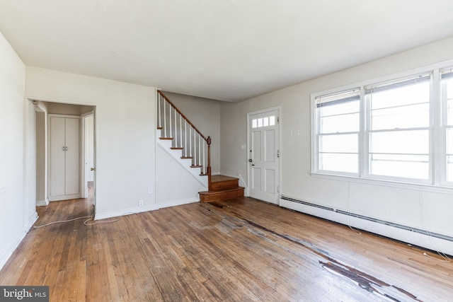 entryway with wood-type flooring and baseboard heating