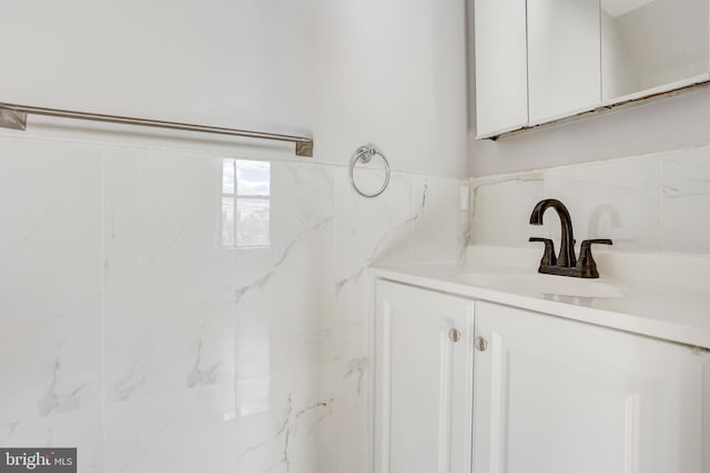 bathroom with tile walls and vanity