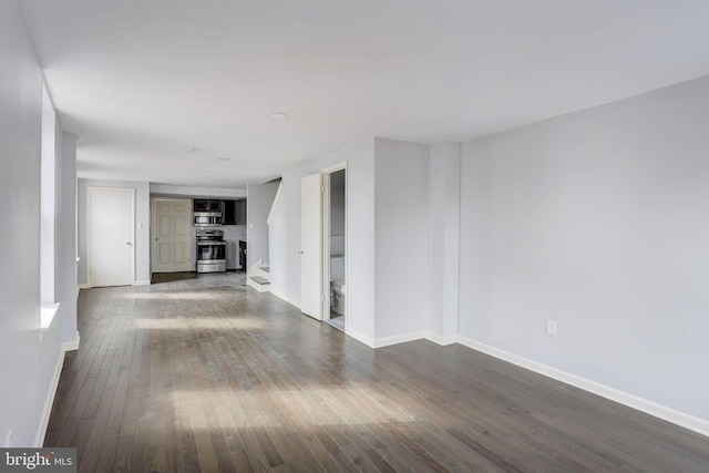 unfurnished living room with dark wood-type flooring