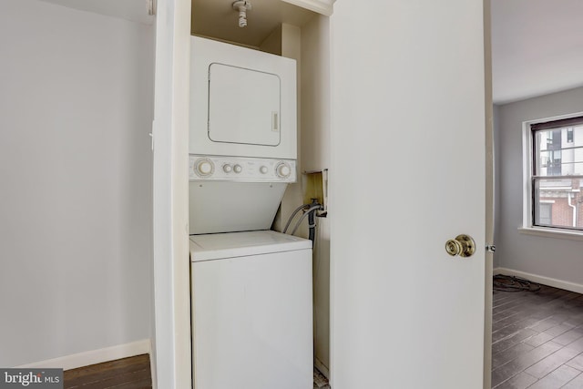 laundry room with dark wood-type flooring, stacked washer / drying machine, and hookup for a washing machine