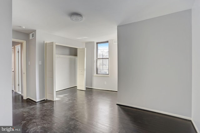 empty room with dark hardwood / wood-style floors