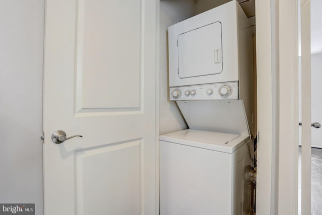 clothes washing area with stacked washer and dryer