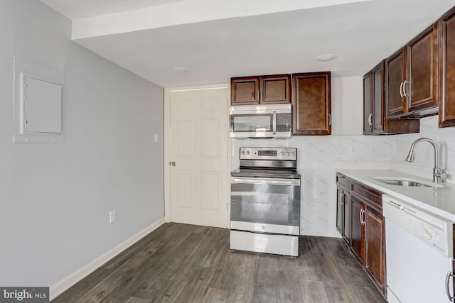 kitchen with backsplash, dark hardwood / wood-style floors, sink, stainless steel appliances, and dark brown cabinets