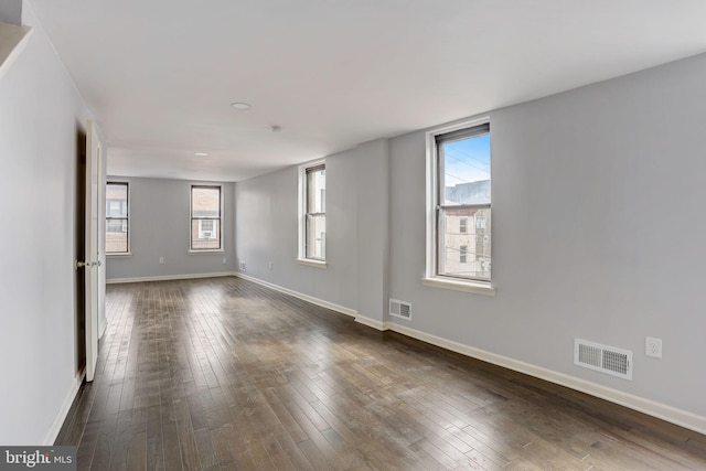 unfurnished room featuring dark hardwood / wood-style floors