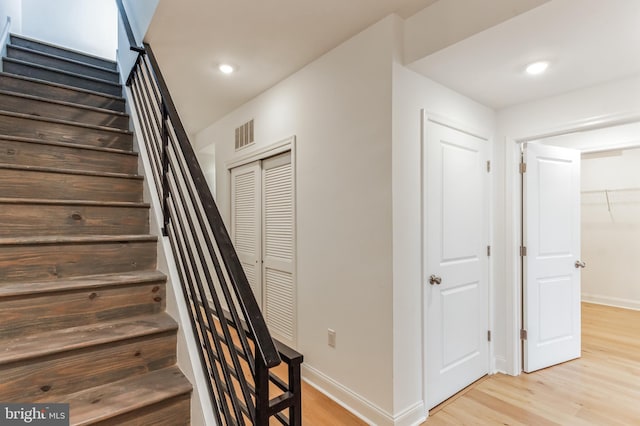 staircase with light hardwood / wood-style flooring