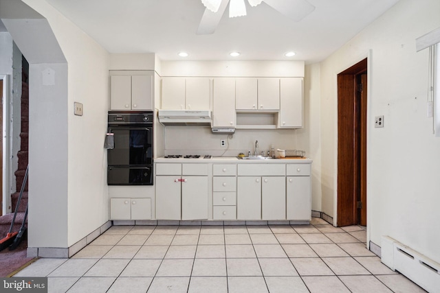 kitchen featuring ceiling fan, light tile flooring, white cabinetry, and sink