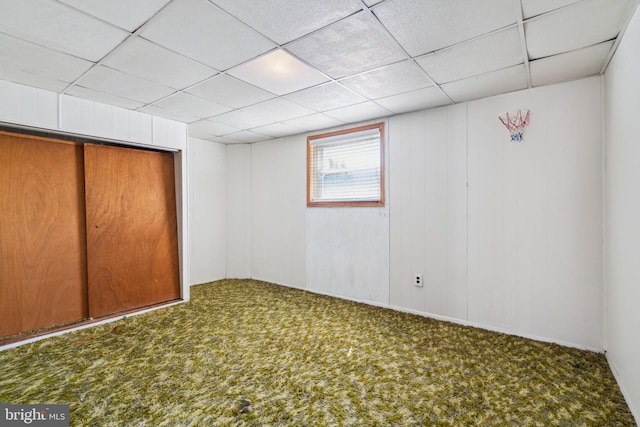 interior space with carpet flooring and a drop ceiling