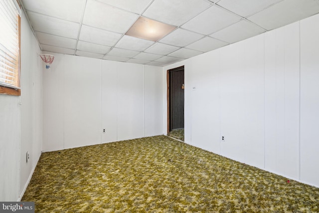 carpeted empty room with a drop ceiling