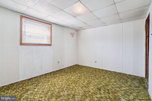 unfurnished room with carpet floors and a drop ceiling