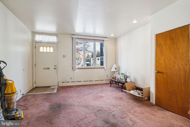 entryway featuring baseboard heating and light carpet