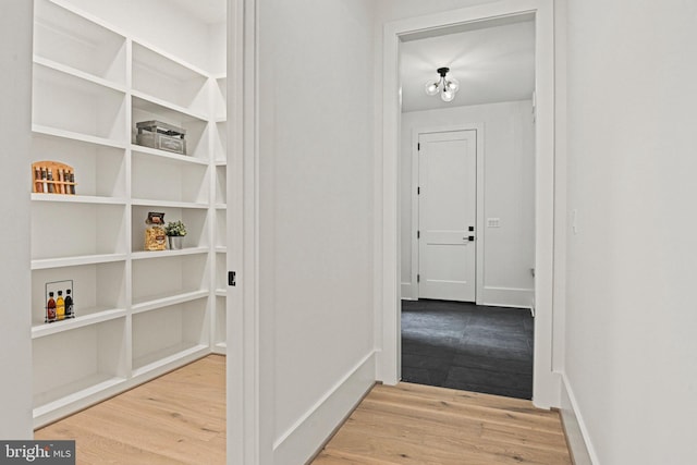 corridor with light hardwood / wood-style flooring