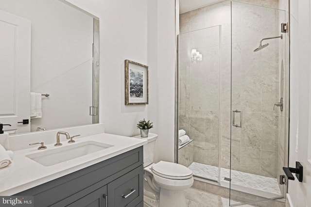 bathroom with vanity, a shower with shower door, and toilet