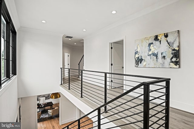 hall with hardwood / wood-style flooring and ornamental molding