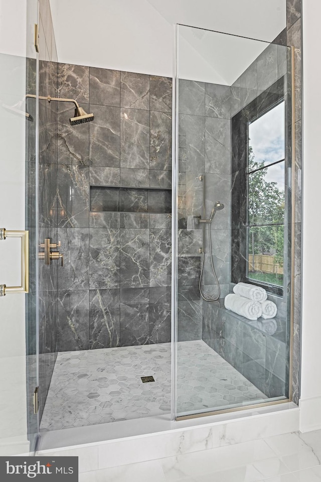 bathroom featuring a shower with shower door