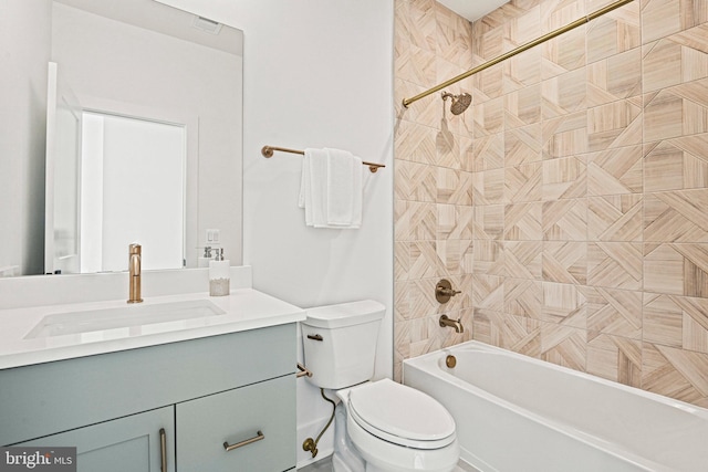 full bathroom with tiled shower / bath, vanity, and toilet