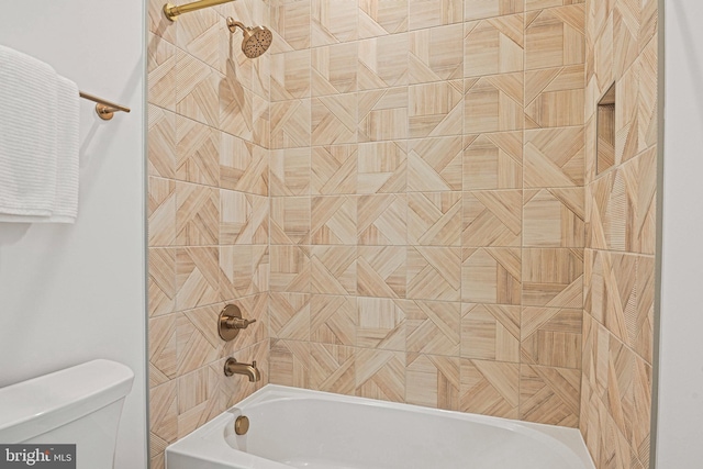 bathroom featuring toilet and tiled shower / bath combo