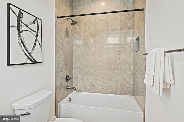 bathroom with toilet and tiled shower / bath combo