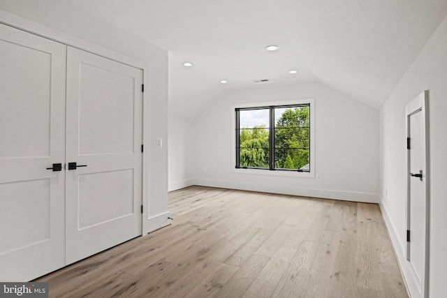 bonus room featuring light hardwood / wood-style flooring and vaulted ceiling