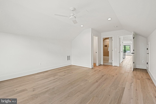 additional living space featuring ceiling fan, lofted ceiling, and light hardwood / wood-style flooring