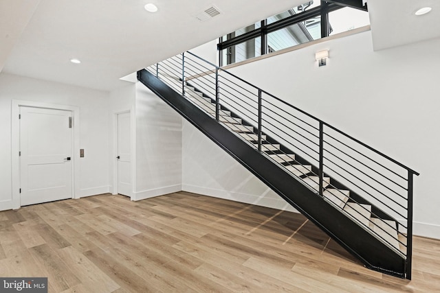 stairs featuring hardwood / wood-style flooring