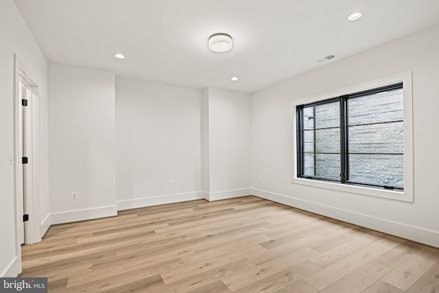 unfurnished room with light wood-type flooring