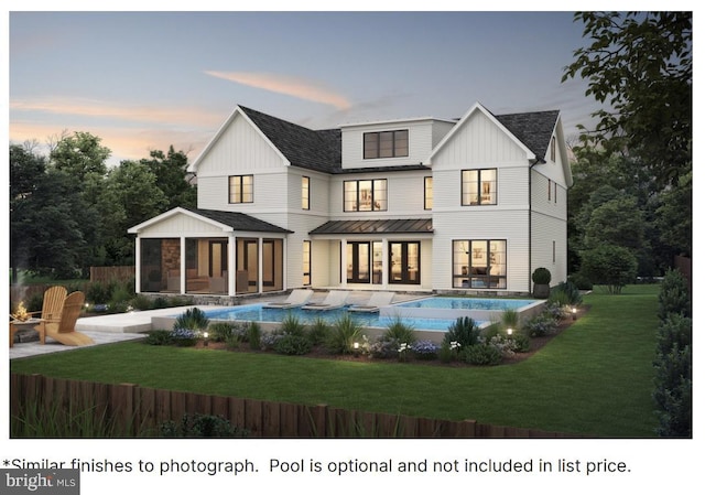 back house at dusk with a fenced in pool, a sunroom, and a lawn