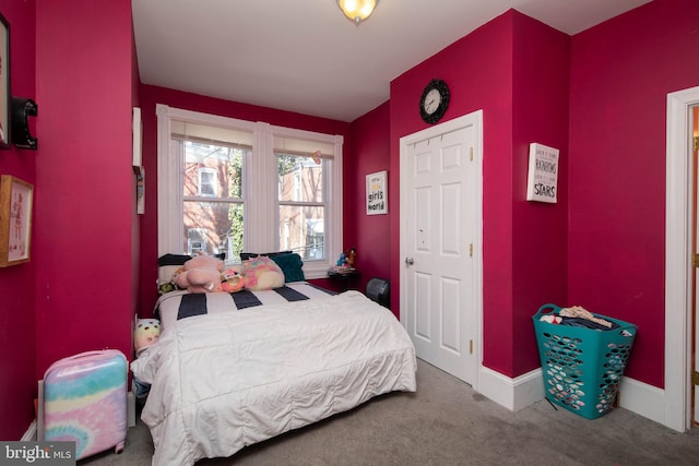 bedroom featuring dark colored carpet