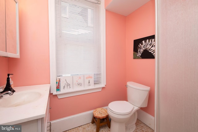 bathroom featuring vanity, tile floors, and toilet