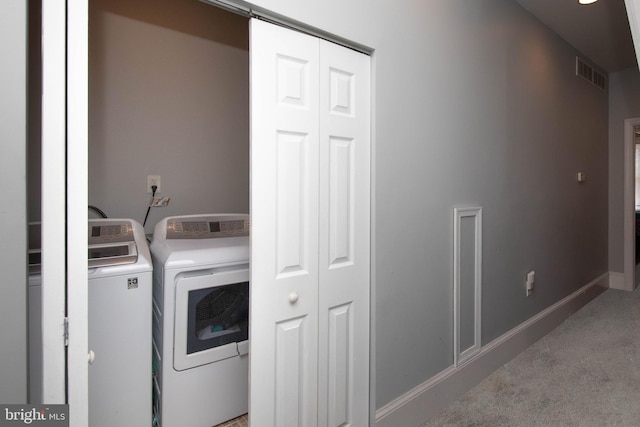 laundry area featuring washer and dryer and carpet floors