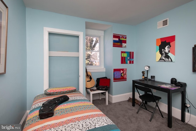 bedroom featuring dark colored carpet