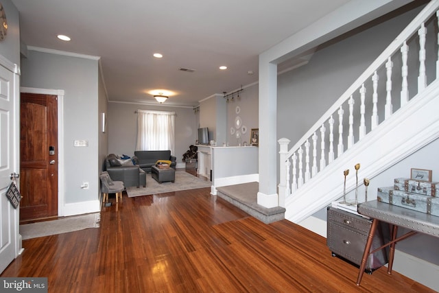 entryway with crown molding and dark hardwood / wood-style floors