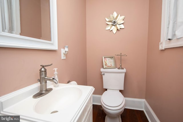 bathroom with toilet, oversized vanity, and wood-type flooring