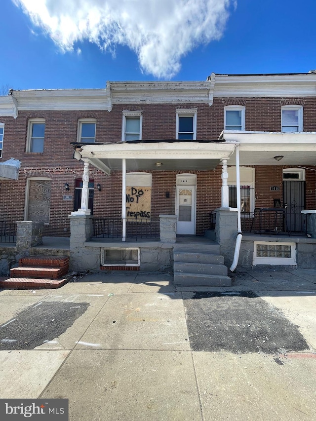 townhome / multi-family property with covered porch