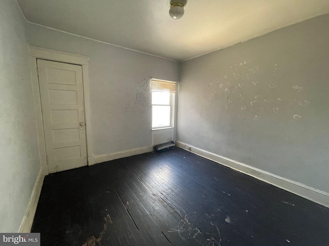 empty room with dark hardwood / wood-style floors