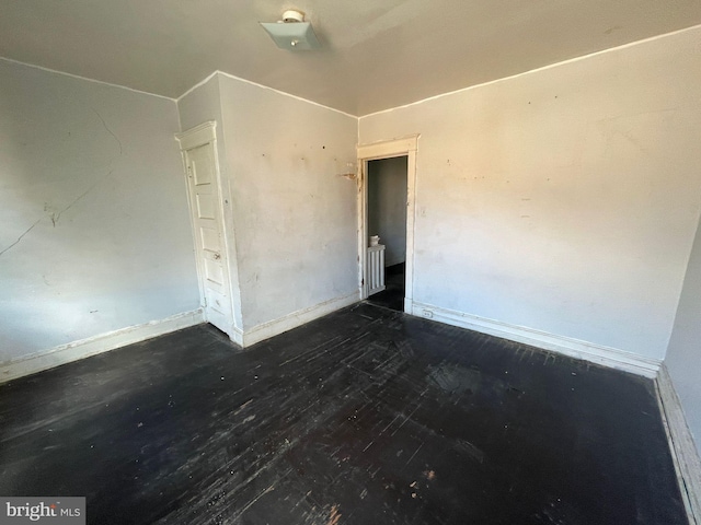 spare room with dark hardwood / wood-style flooring