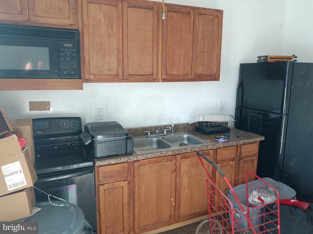 kitchen featuring sink and black appliances