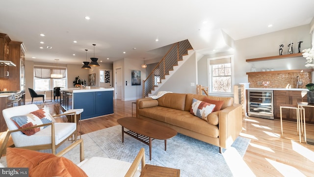 living room featuring wine cooler and light hardwood / wood-style floors