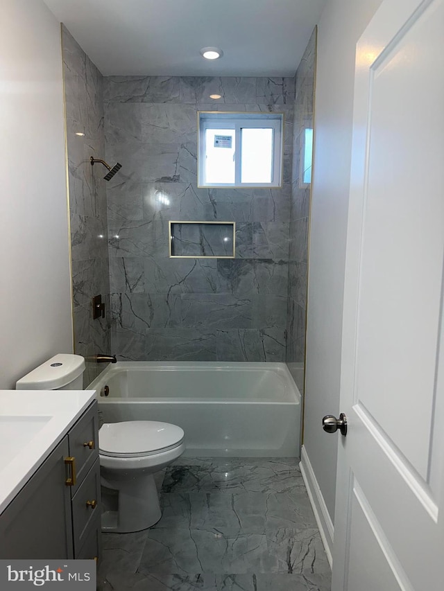 full bathroom with tiled shower / bath combo, toilet, vanity, and tile flooring