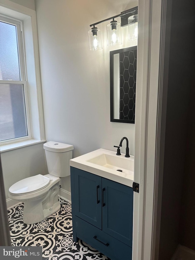 bathroom featuring tile floors, toilet, and vanity