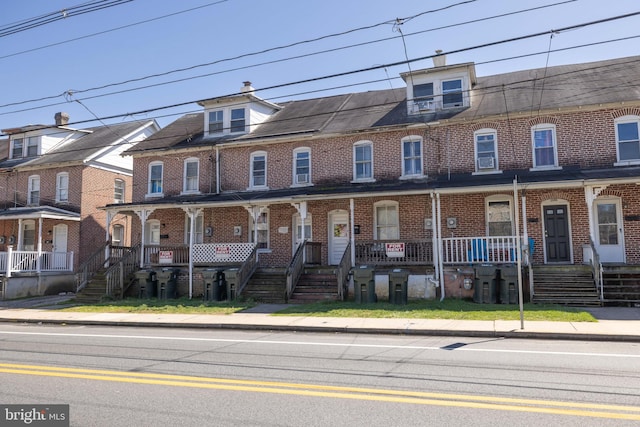 view of property featuring covered porch