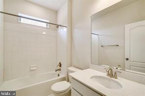 full bathroom featuring vanity, toilet, and tiled shower / bath combo