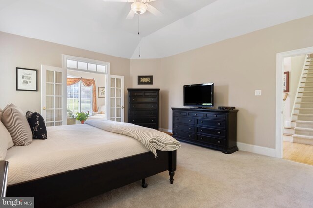 bedroom with french doors, light colored carpet, ceiling fan, and vaulted ceiling