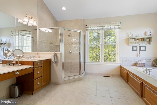 bathroom featuring tile patterned floors, vanity, separate shower and tub, and vaulted ceiling