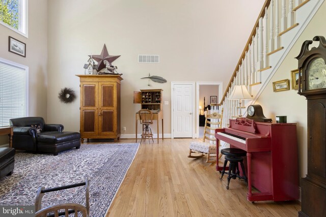 living room featuring hardwood / wood-style floors and a high ceiling