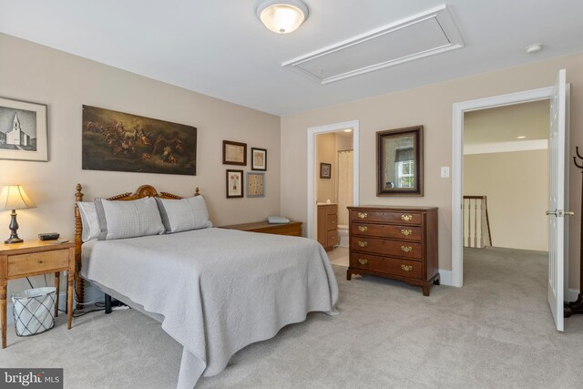 bedroom featuring light colored carpet and ensuite bathroom