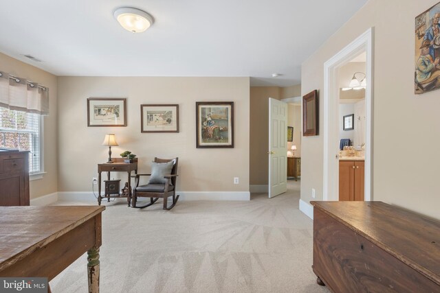 living area with light colored carpet