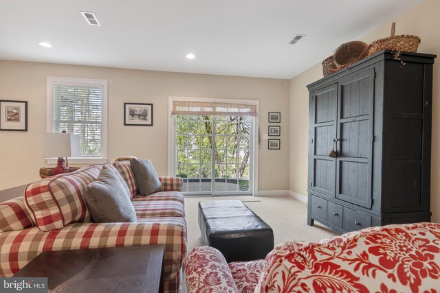 living room featuring carpet and a wealth of natural light