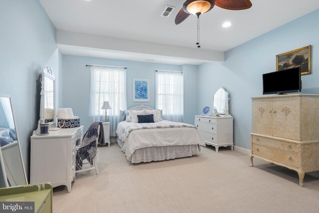 bedroom with ceiling fan and light colored carpet